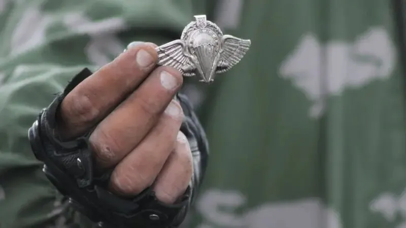 Бойовик ЛНР тримає знак українських десантників на місці падіння Іл-76